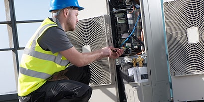 man working on electrical junction box
