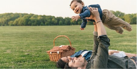Family having picnic in a green meadow
