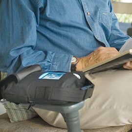 Man sitting in chair with ACTIV.A.C.™ Therapy Unit