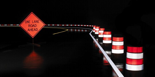 road with traffic cones and a sign
