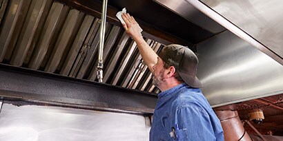 grease being cleaned off a griddle
