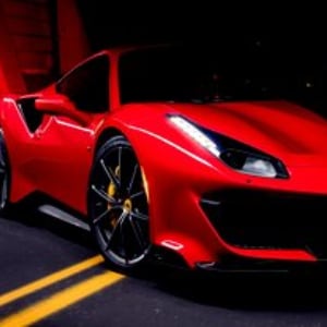 red sports car parked in a garage
