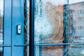 Shattered window held intact by protective window film