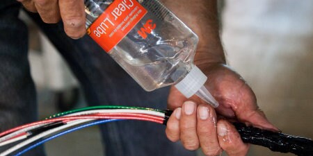 worker using 3M Wire Lubricants to coat wires
