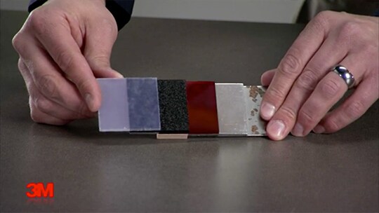 A close-up of hands holding a sample of different colors
