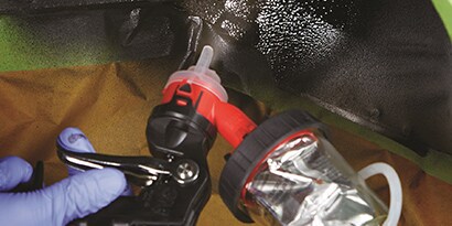 pressure cup applying heavy coatings to wheel well
