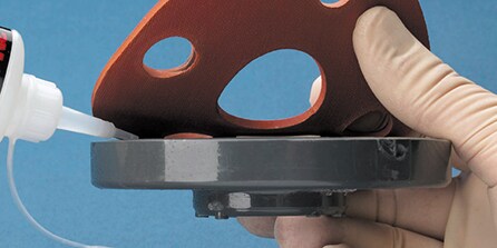 image of a hand holding a gasket
