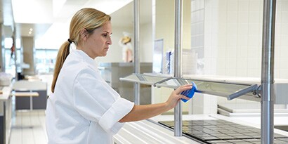 Woman cleaning commercial kitchen
