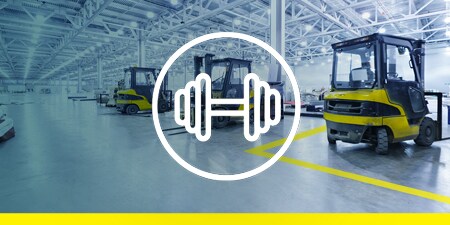 Image of forklifts on a taped-off factory floor; overlay of a barbell icon representing strength and durability
