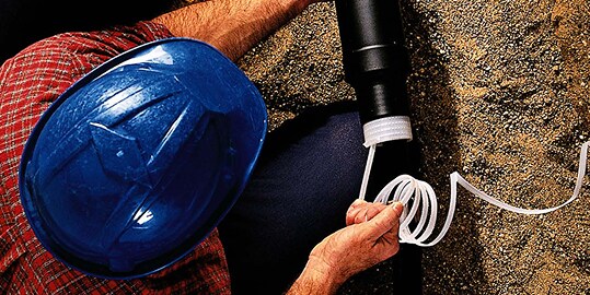worker installing 3M Cold Shrink Splice on electrical cable
