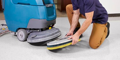 scotchbrite clean and shine pad being applied on a commercial cleaning machine 
