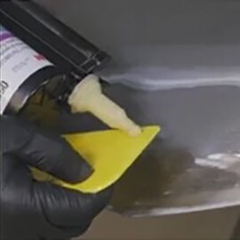 worker doing small damage metal auto dent repair