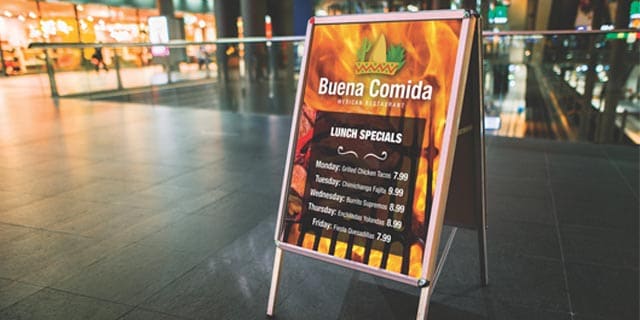 A sidewalk lunch sign showing a mexican restaurant's lunch specials in front of a fire graphic, wrapped using 3m IJ35C film.
