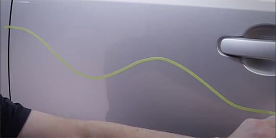 Text “Put pressure on entire width of crepe paper tape while stretching it” as worker use it
