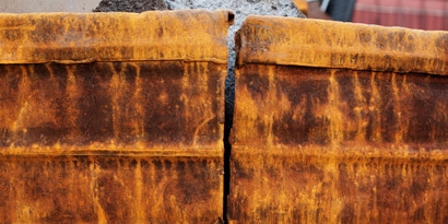 Adhering to rusty iron can be challenging; surface preparation can impact adhesive effectiveness.
