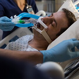 critial care patient being taken care of by medial staff