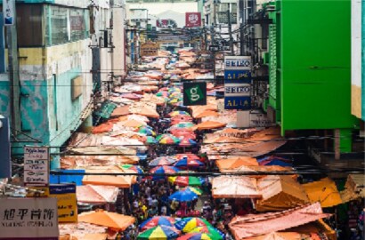Crowded market place with umbrellas
