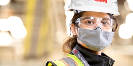 worker wearing various 3M Personal Protective Equipment, or PPE
