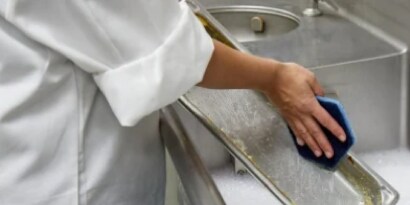 person cleaning a sink
