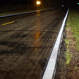 Retroreflective road markings on a wet road