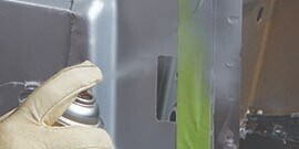 applying weld-through primer to future weld site