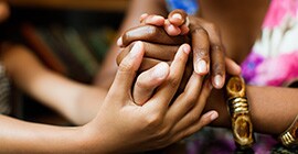 Image of many hands holding together
