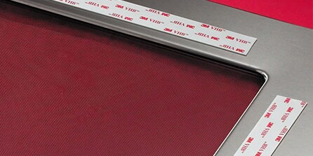mounting and trim attachments adhered to a surface
