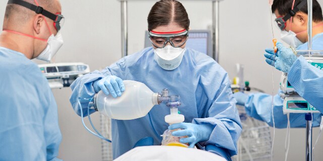 A person wearing surgical gear and mask
