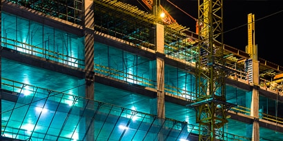A building under construction at night
