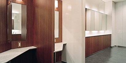 The sleek interior of a building has wood-grain walls surface finish
