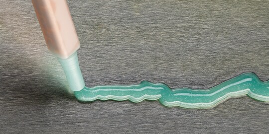 A close-up of a tube of green liquid

