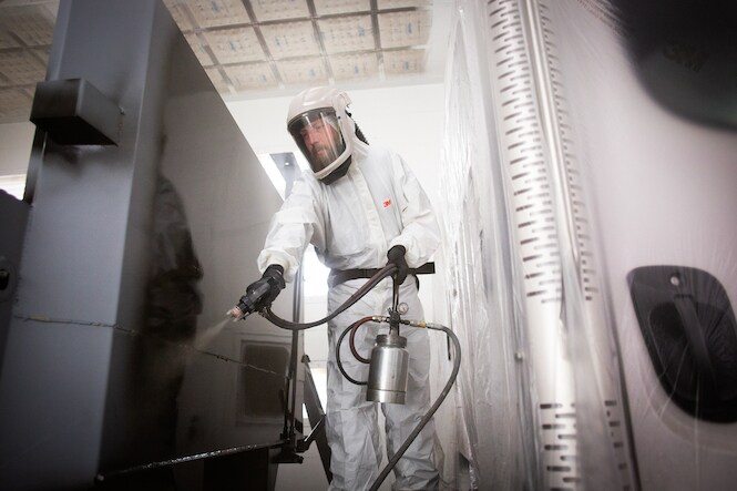 person using an spray gun for cars best used for painting
