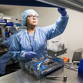 Medical staff in reaching for medical equipment