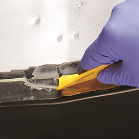 Tight coat being applied to vehicle seam