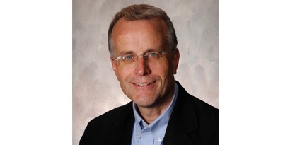 person wearing glasses and a black jacket
